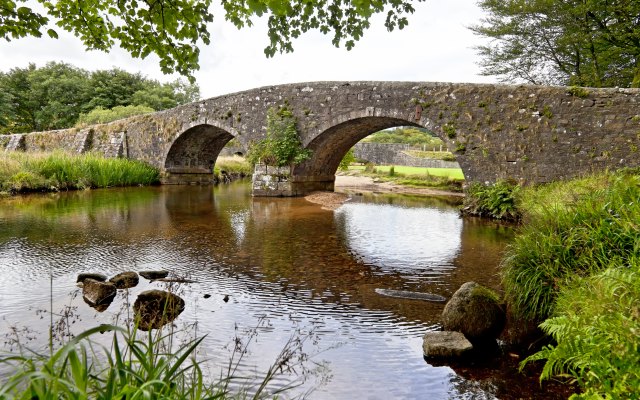 A stone bridge over a river in the countryside