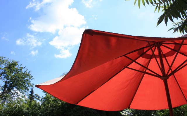 Large garden umbrella in sunshine