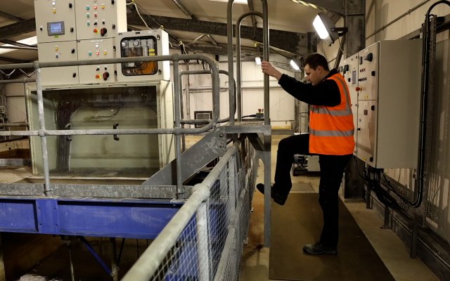 Person in high visibility jacket inside technical centre
