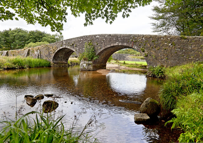 A stone bridge over a river in the countryside